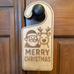 Wooden door hanger with Christmas design and 'Merry Christmas' text on a wooden door.