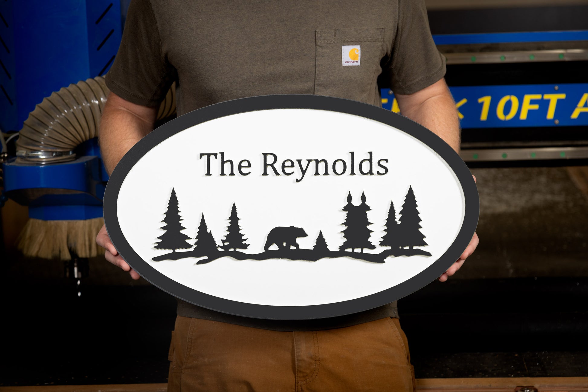 black oval large house sign mountain trees bear custom