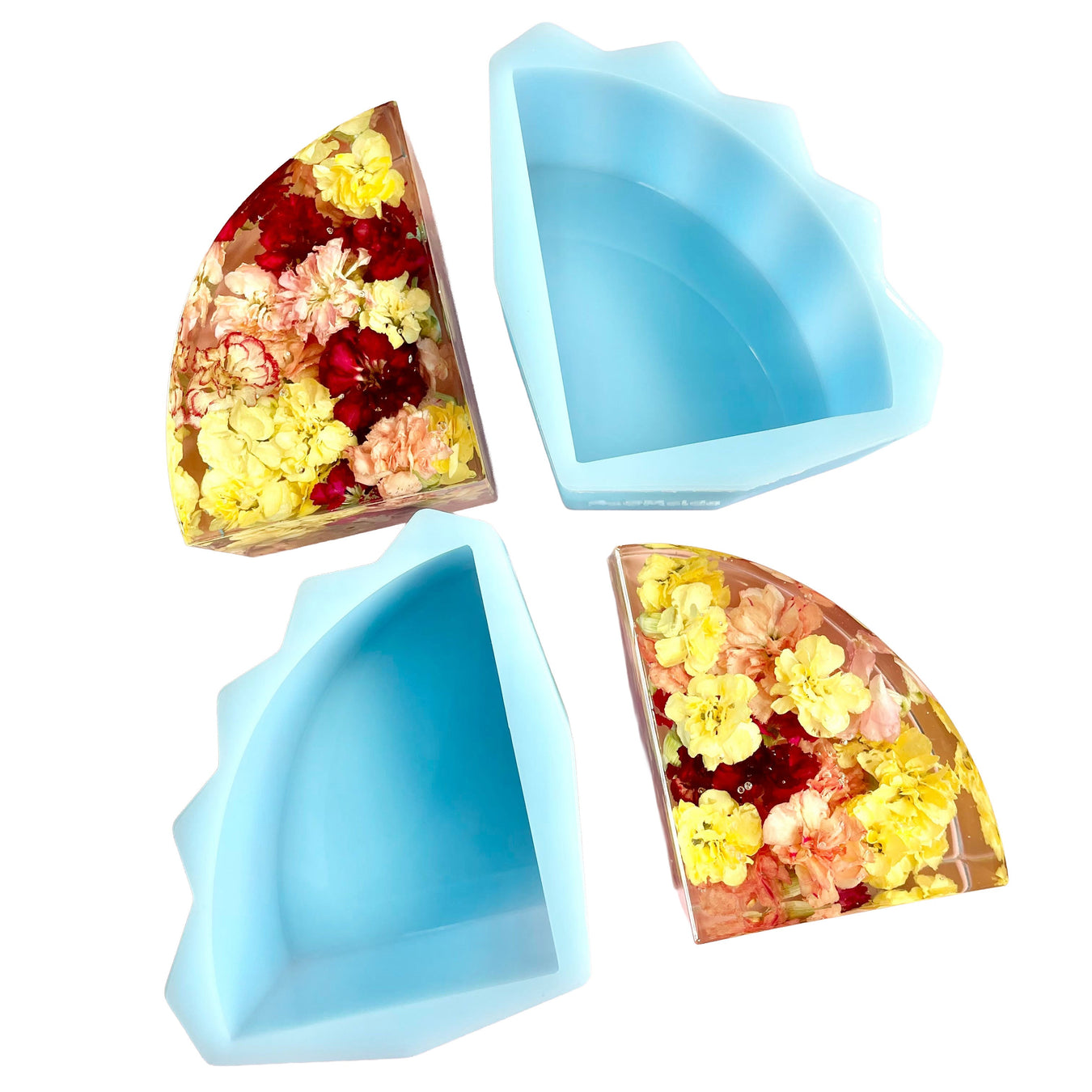 Three silicone mold shapes filled with colorful flowers on a white background